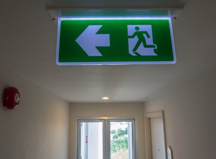  A emergency light, situated in a commercial property, that is tested frequently to meet emergency lighting requirements.  